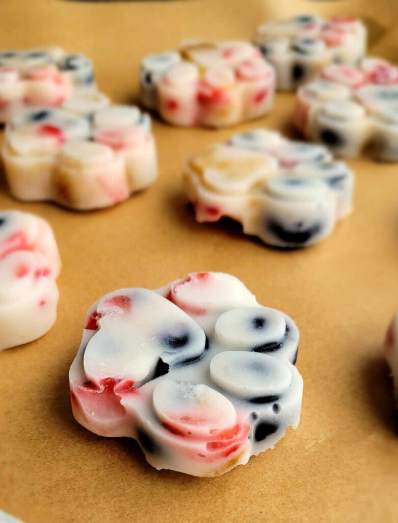 paw print frozen treats for dogs on a cooling sheet