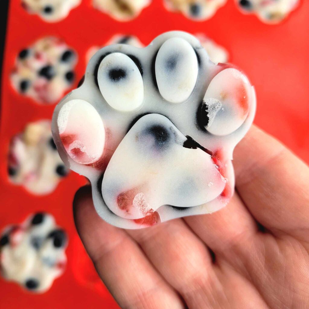 frozen dog treat in the shape of a dog paw