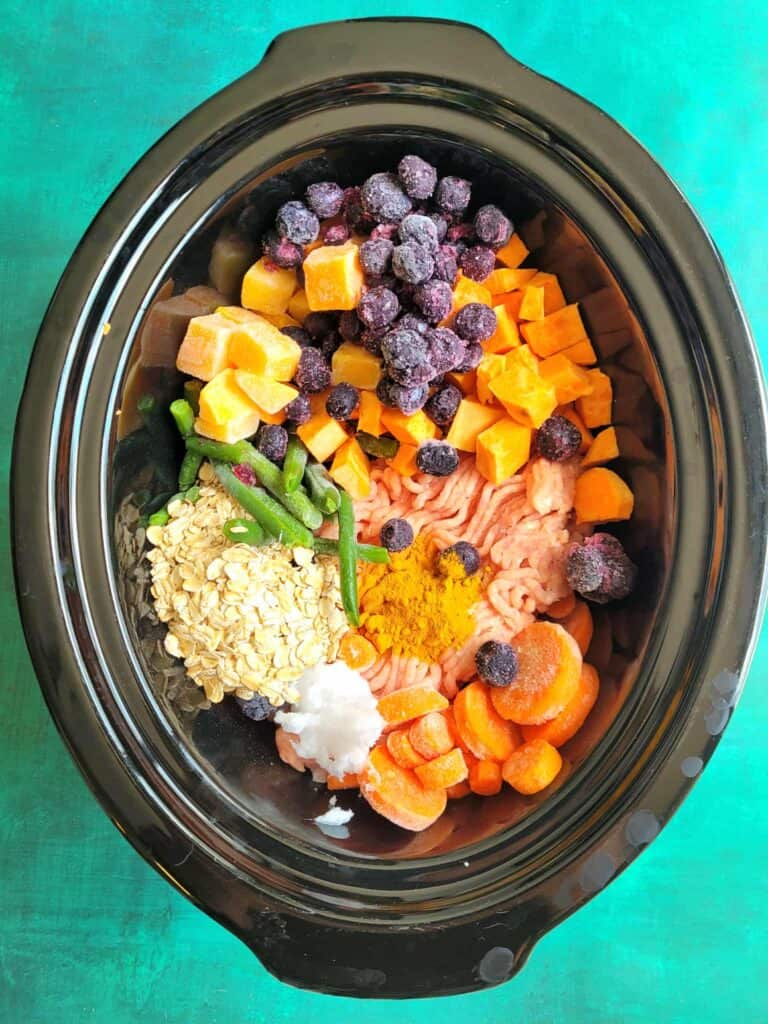 Whip up this slow cooker harvest dog food recipe with ground turkey, sweet potato, blueberries, frozen veggies, green beans & oats. A DIY fall-inspired homemade dog food that’s healthy, freezer-friendly, and perfect for senior pups too!
