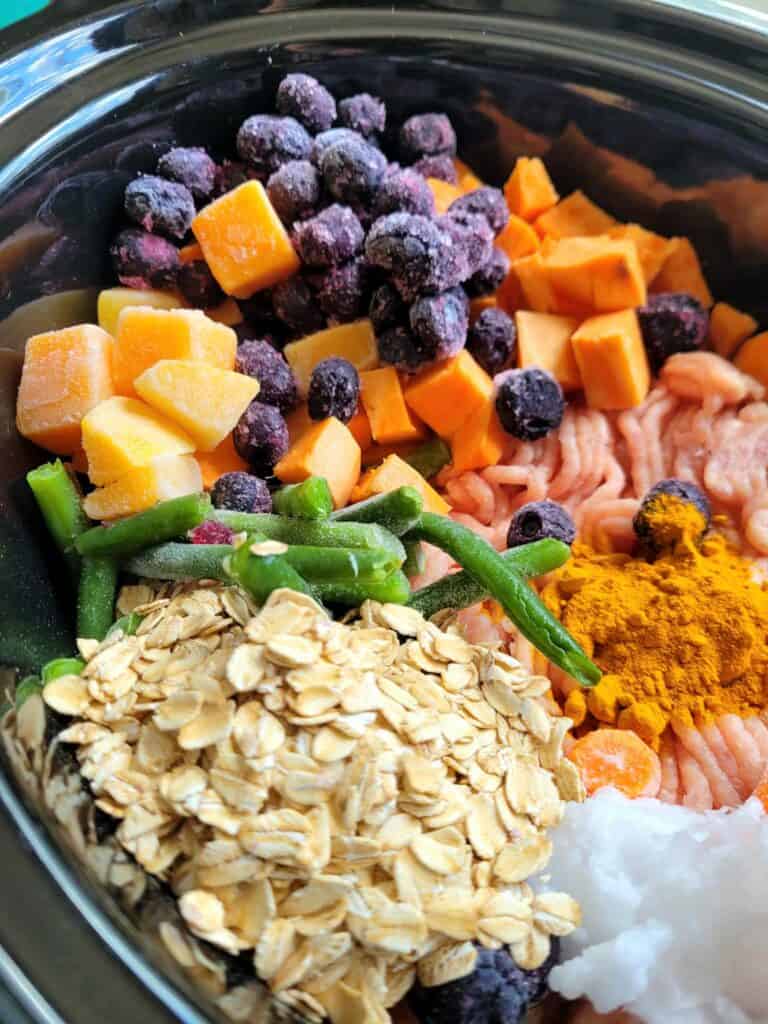 Whip up this slow cooker harvest dog food recipe with ground turkey, sweet potato, blueberries, frozen veggies, green beans & oats. A DIY fall-inspired homemade dog food that’s healthy, freezer-friendly, and perfect for senior pups too!