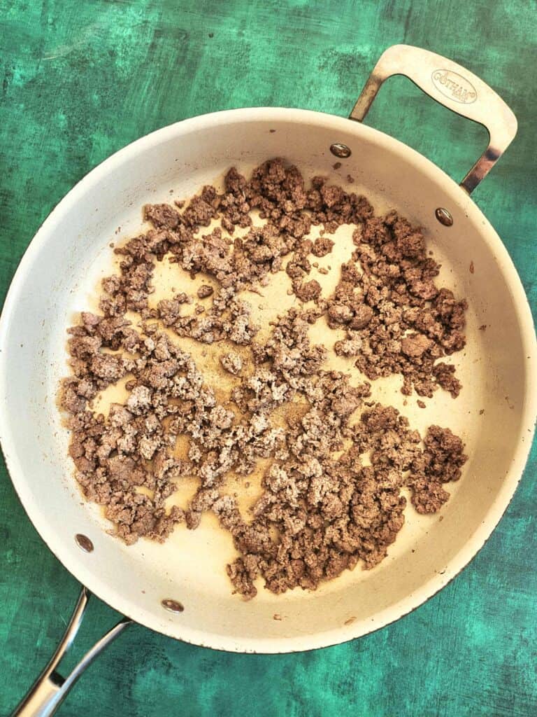 brown ground turkey in a skillet for tummy tamer stew
