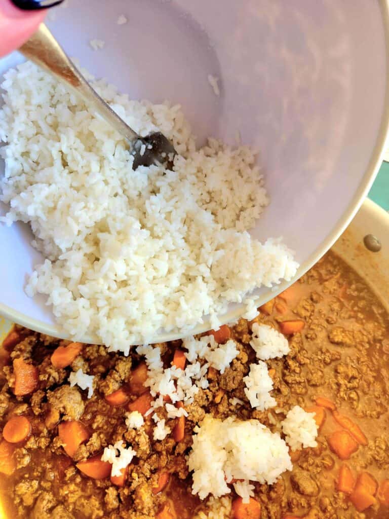 add in white rice to the simmering stew