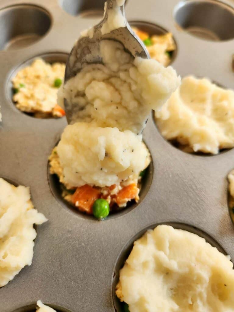 adding mashed potatoes to the top of dog friendly turkey pot pies