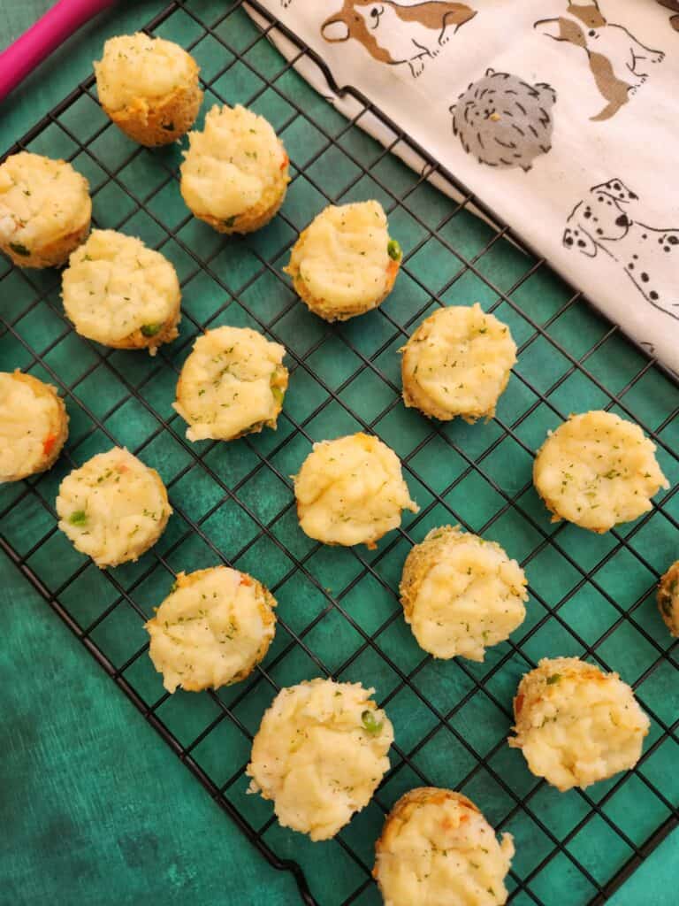 Mini dog pot pies cooling on a baking rack