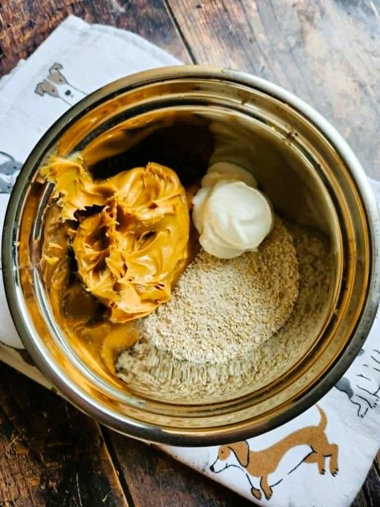 mixing peanut butter oat flour and Greek yogurt to make soft dog pill pocket dough