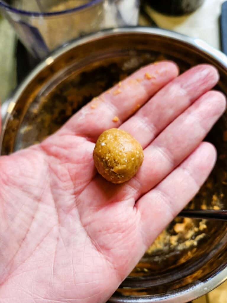 rolling small peanut butter dough balls for homemade dog pill pockets recipe