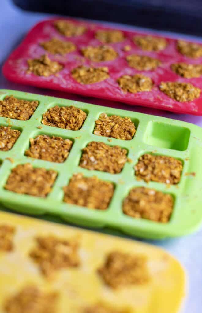 Rustic homemade dog treats made with pumpkin and chamomile displayed on kitchen counter